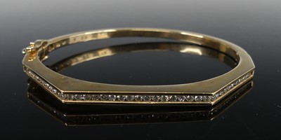 Lot 2285 - A 9ct yellow gold diamond hinged bangle,...