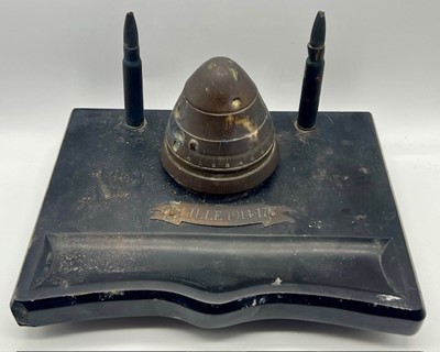 Lot 652 - A WWI trench art inkwell, a brass fuse hinged...