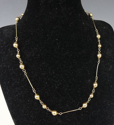 Lot 2221 - A 9ct gold necklace, arranged as triple ball...