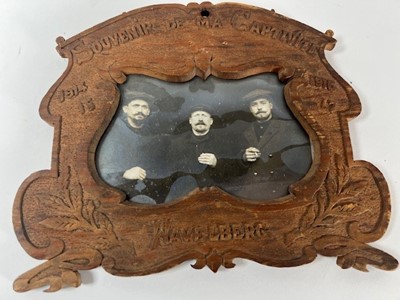 Lot 662 - A wooden photo frame with carved decoration...