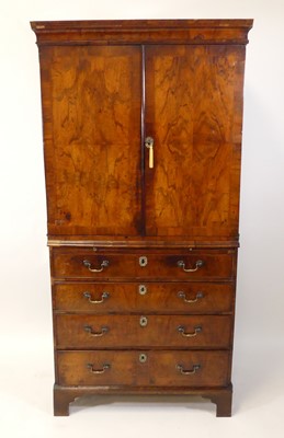 Lot 2548 - A mid-18th century walnut linenpress, the twin...