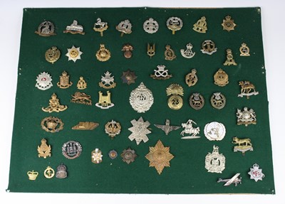 Lot 552 - A collection of assorted cap badges and...