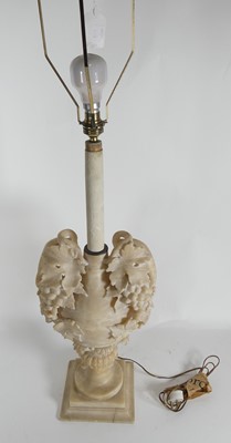 Lot 12 - A carved alabaster lamp base decorated with...