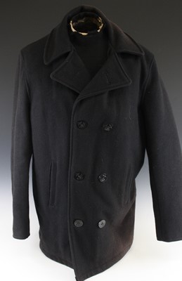 Lot 655 - A Naval double breasted black pea coat,...