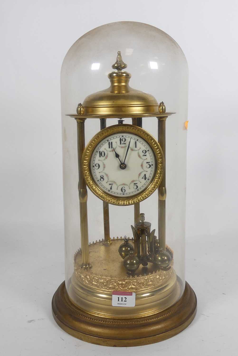 Lot 112 - A brass anniversary clock having white enamel...