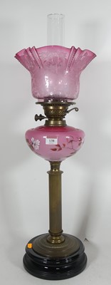 Lot 138 - A Victorian oil lamp with cranberry acid...