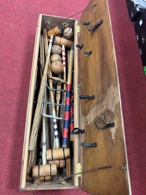 Lot 170 - A wooden cased croquet set with indistinct...