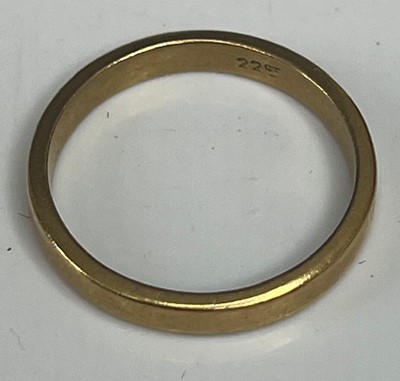 Lot 342 - A yellow metal wedding band, stamped 22K but...