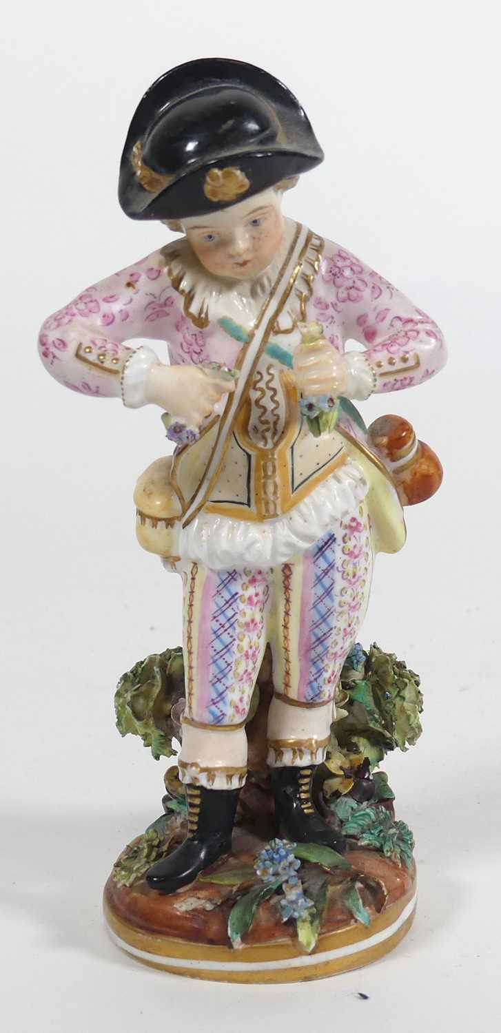 Lot 240 - A Crown Derby figure of a boy holding flowers,...