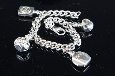 Lot 369 - A Christian Dior polished steel curblink charm...