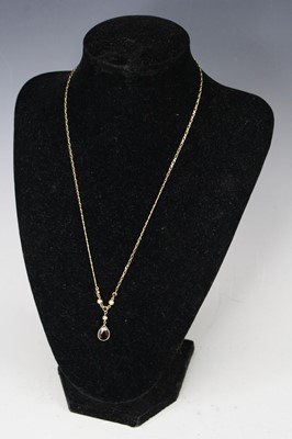 Lot 411 - A modern 9ct gold necklet, with garnet drop,...