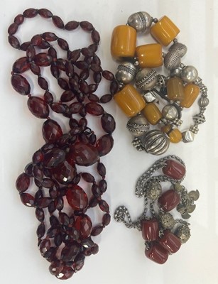 Lot 433 - Two faceted and beaded 'cherry amber'...