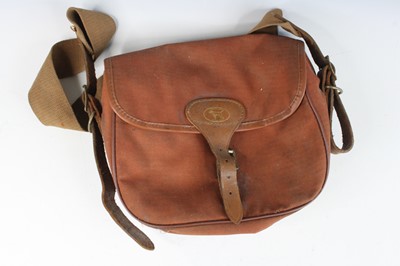 Lot 848 - A brown canvas cartridge bag with leather...