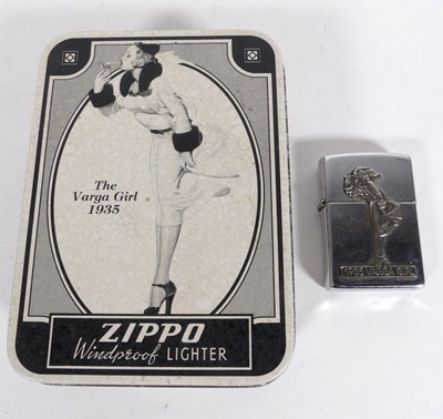 Lot 566 - A Zippo lighter, 1935 Varga Girl, in tin