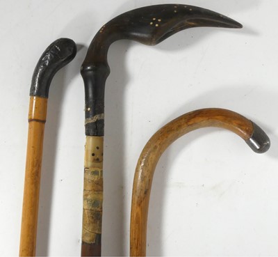 Lot 584 - A silver tipped walking stick, together with...