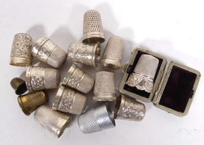 Lot 517 - A collection of thimbles, to include silver...