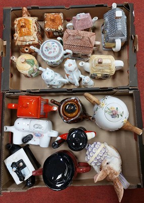 Lot 642 - A collection of novelty teapots, to include an...