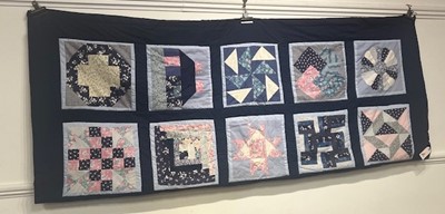 Lot 709 - A patchwork quilt, blue background and...