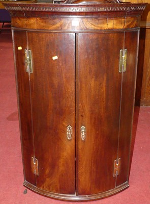 Lot 1132 - A George III mahogany hanging corner cupboard...