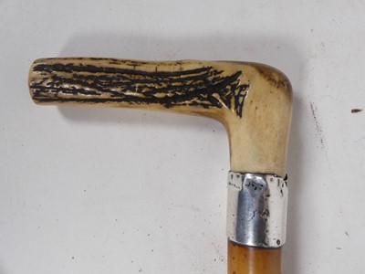 Lot 606 - An antler handled walking stick with silver...