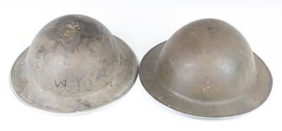 Lot 575 - A WW II Brodie pattern steel helmet, having a...