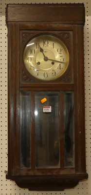 Lot 1151 - A circa 1920s oak droptrunk wall clock, h.73cm