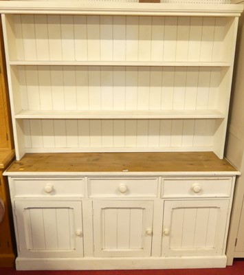 Lot 1141 - A white painted pine farmhouse dresser, with...