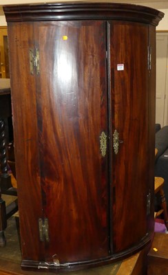 Lot 1325 - A George III mahogany hanging bow front corner...