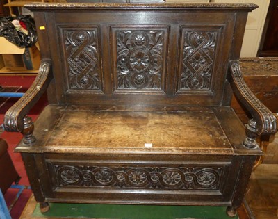 Lot 1330 - A late Victorian carved oak settle, width 109cm