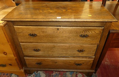 Lot 1245 - An early 20th century oak chest, of three long...