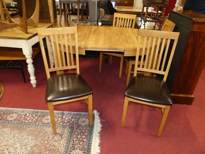 Lot 1263 - A contemporary blond oak extending dining...