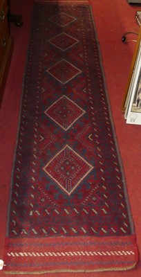 Lot 1161 - A Persian woollen red ground hall runner,...