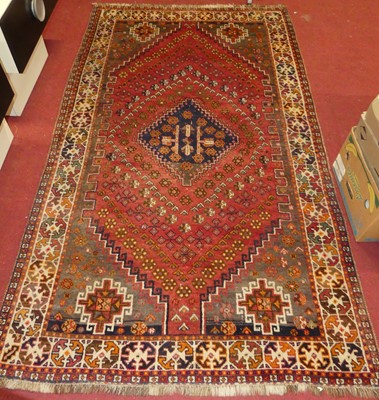 Lot 1163 - A Turkish woollen red ground rug, decorated...