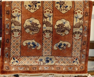 Lot 1165 - A Chinese superwash peach ground woollen rug,...