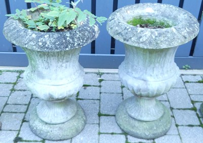 Lot 1358 - A pair of reconstituted stone pedestal...