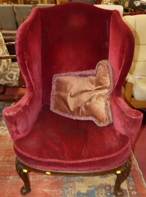 Lot 1299 - A Georgian style mahogany framed wing armchair,...