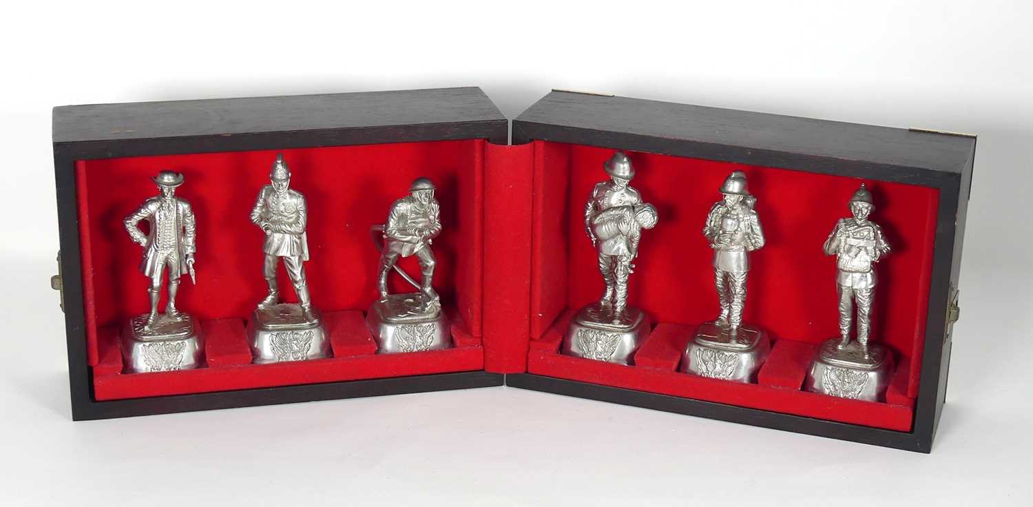 Lot 129 - A set of six cast pewter figures of firemen,...