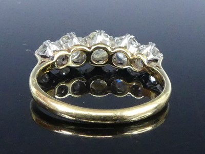 Lot A yellow and white metal diamond half-hoop...