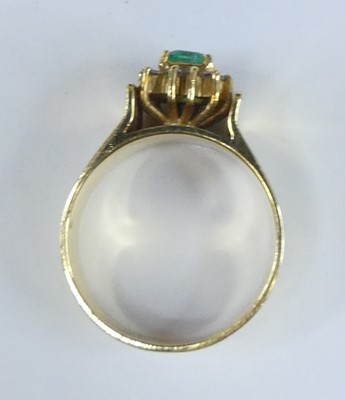Lot 2563 - A yellow metal, emerald and diamond...