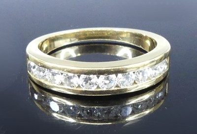 Lot 2549 - A yellow metal diamond half eternity ring,...