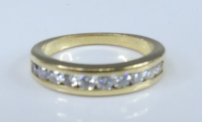 Lot 2549 - A yellow metal diamond half eternity ring,...