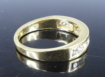 Lot 2549 - A yellow metal diamond half eternity ring,...