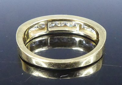 Lot 2549 - A yellow metal diamond half eternity ring,...