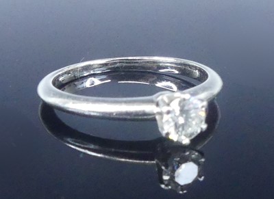 Lot A white metal diamond solitaire ring,...