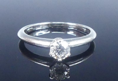 Lot A white metal diamond solitaire ring,...