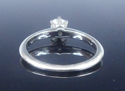 Lot A white metal diamond solitaire ring,...