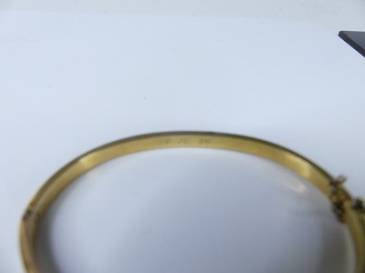 Lot 2572 - A yellow and white metal hinged hollow oval...