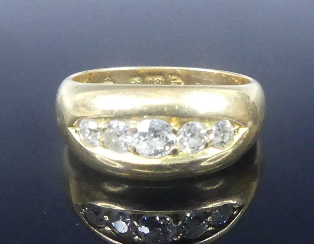 Lot 2573 - An 18ct yellow gold diamond half eternity ring,...