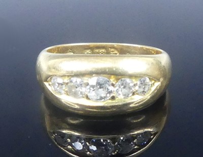 Lot 2573 - An 18ct yellow gold diamond half eternity ring,...