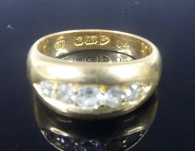 Lot 2573 - An 18ct yellow gold diamond half eternity ring,...